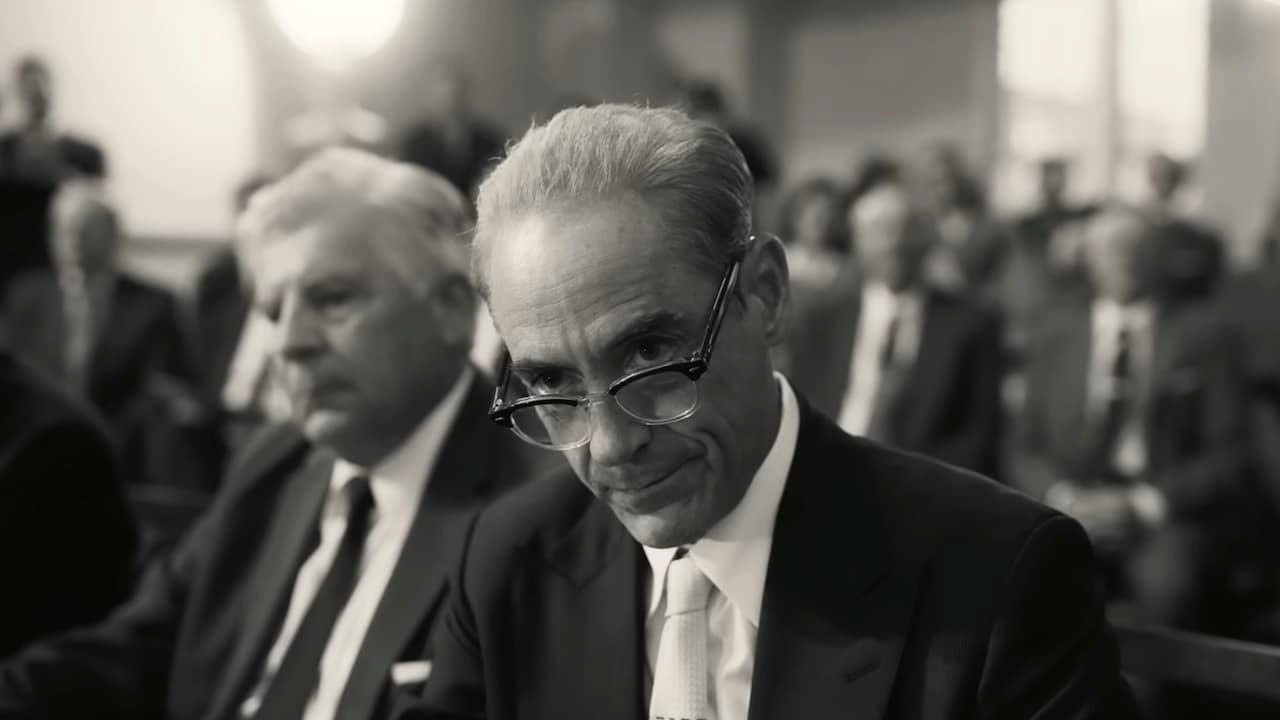 Robert Downey Jr. as Strauss in Oppenheimer. Image is in black and white, and he is in front of the Senate.